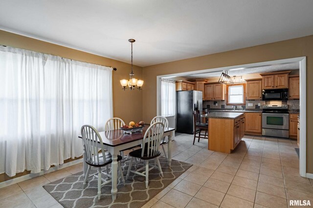 324 N Broadway, Goreville, IL 62939 - dining space featuring light tile patterned flooring and a chandelier