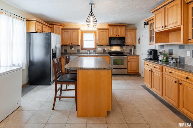 324 N Broadway, Goreville, IL 62939 - kitchen featuring appliances with stainless steel finishes, dark countertops, a sink, and tasteful backsplash