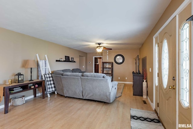 324 N Broadway, Goreville, IL 62939 - living area featuring light wood-style flooring, baseboards, and ceiling fan