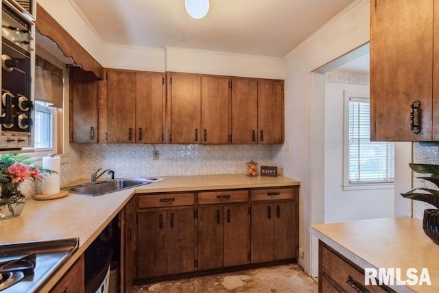 1513 41st St, Rock Island, IL 61201 - kitchen featuring a sink, light countertops, decorative backsplash, stovetop, and brown cabinets
