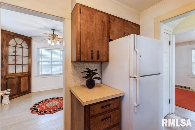 1513 41st St, Rock Island, IL 61201 - kitchen featuring freestanding refrigerator, a ceiling fan, plenty of natural light, light countertops, and crown molding