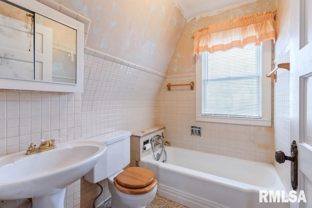 1513 41st St, Rock Island, IL 61201 - full bathroom featuring tile walls, toilet, a sink, a tub to relax in, and vaulted ceiling