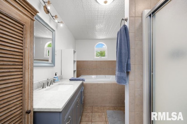 824 S State St, Geneseo, IL 61254 - bathroom with tile patterned floors, vanity, a garden tub, and an enclosed shower