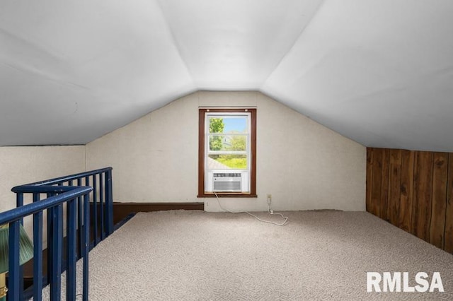 824 S State St, Geneseo, IL 61254 - additional living space with lofted ceiling, carpet floors, cooling unit, and wood walls