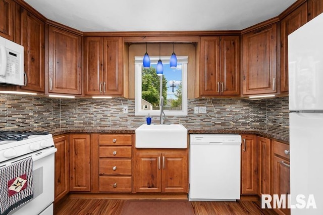 824 S State St, Geneseo, IL 61254 - kitchen with white appliances, a sink, and brown cabinetry