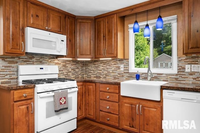 824 S State St, Geneseo, IL 61254 - kitchen with white appliances, a sink, backsplash, and brown cabinets