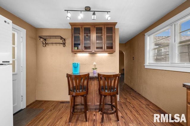 824 S State St, Geneseo, IL 61254 - dining space featuring arched walkways and wood finished floors