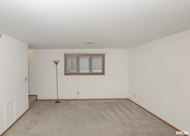 2112 35th St Unit 3, Rock Island, IL 61201 - spare room featuring light carpet and baseboards