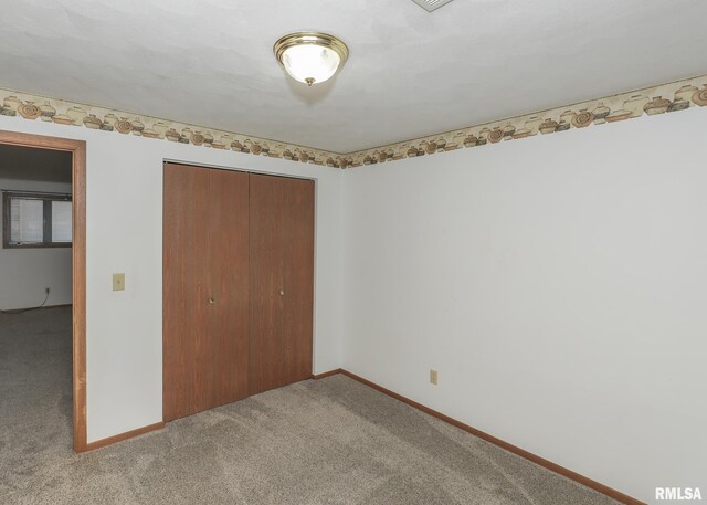 2112 35th St Unit 3, Rock Island, IL 61201 - unfurnished bedroom featuring light colored carpet, a closet, and baseboards