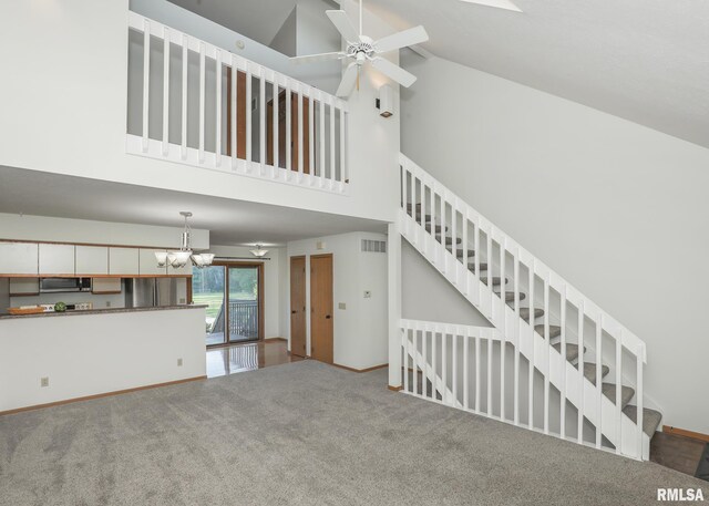 2112 35th St Unit 3, Rock Island, IL 61201 - unfurnished living room with high vaulted ceiling, a ceiling fan, carpet flooring, a chandelier, and stairway