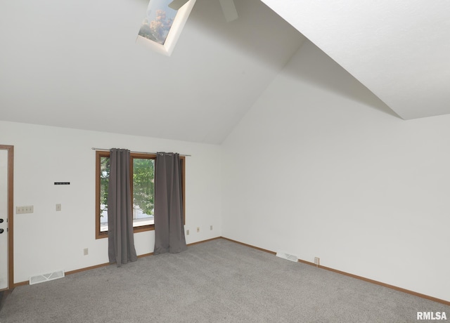 2112 35th St Unit 3, Rock Island, IL 61201 - carpeted empty room featuring lofted ceiling, baseboards, a ceiling fan, and a skylight