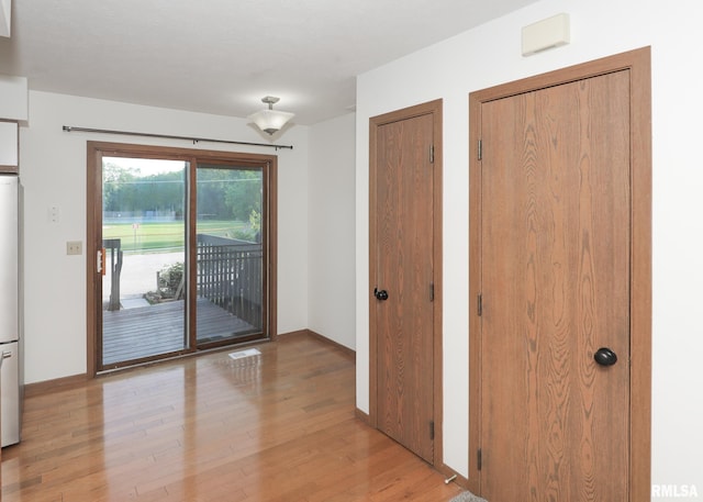 2112 35th St Unit 3, Rock Island, IL 61201 - doorway to outside featuring light wood-style flooring and baseboards
