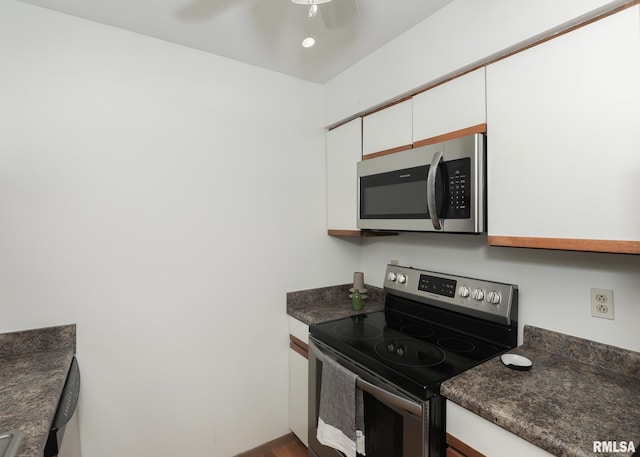 2112 35th St Unit 3, Rock Island, IL 61201 - kitchen with stainless steel appliances, dark countertops, white cabinetry, dark wood-type flooring, and a ceiling fan