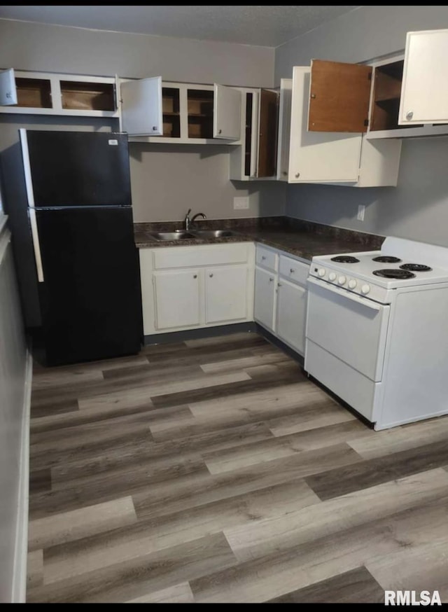 2705 N Lincoln Ave, Davenport, IA 52804 - kitchen featuring white electric range, open shelves, freestanding refrigerator, and dark countertops