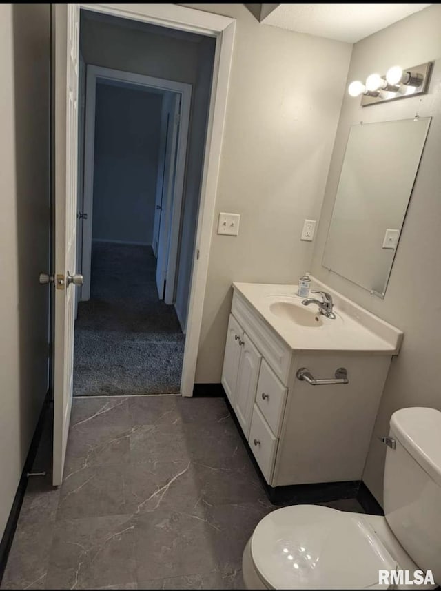 2705 N Lincoln Ave, Davenport, IA 52804 - bathroom with toilet, vanity, marble finish floors, and baseboards