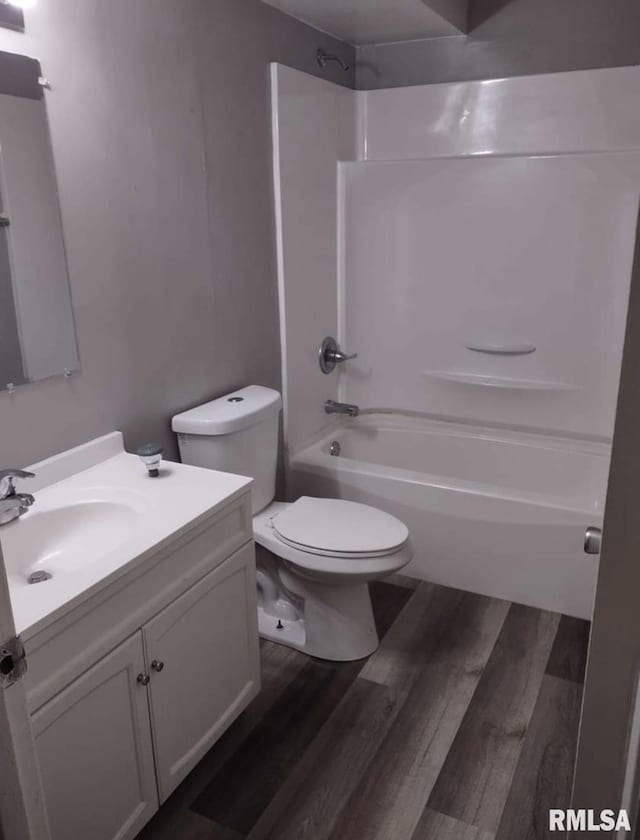 2705 N Lincoln Ave, Davenport, IA 52804 - bathroom with wood finished floors, toilet, tub / shower combination, and vanity