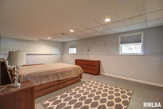 bedroom with baseboards, recessed lighting, and a drop ceiling