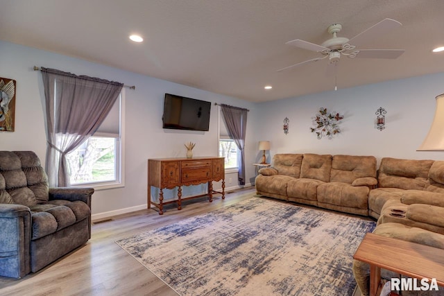 living area with wood finished floors, ceiling fan, recessed lighting, and baseboards