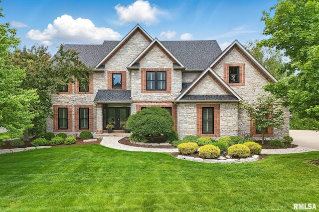6531 Eagle Ridge Rd, Bettendorf, IA 52722 - craftsman inspired home with stone siding, french doors, a front yard, and roof with shingles