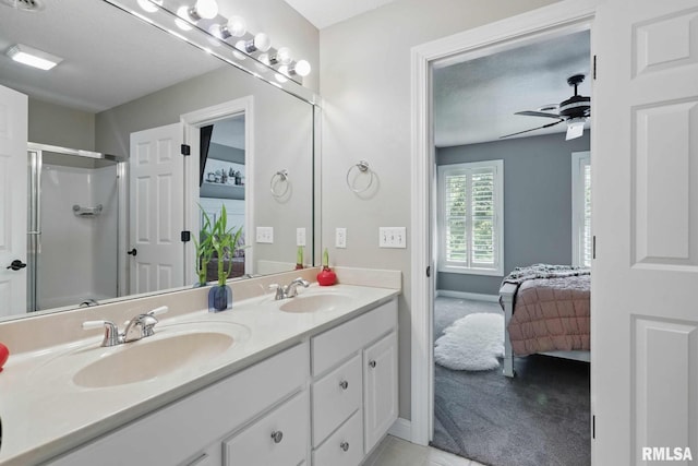 6531 Eagle Ridge Rd, Bettendorf, IA 52722 - ensuite bathroom with double vanity, a shower stall, ceiling fan, and baseboards