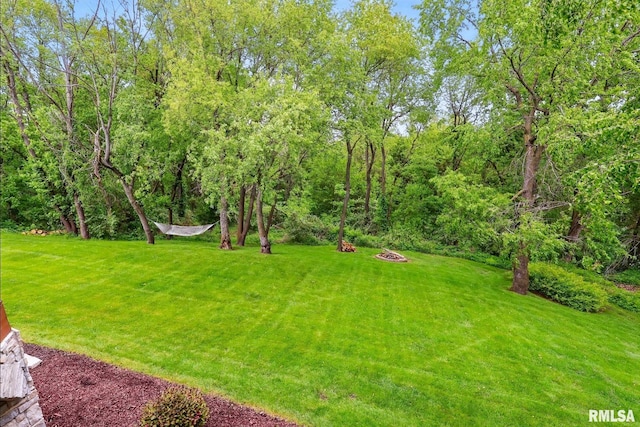 6531 Eagle Ridge Rd, Bettendorf, IA 52722 - view of green lawn with an outdoor fire pit
