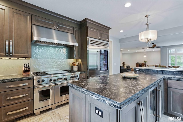 6531 Eagle Ridge Rd, Bettendorf, IA 52722 - kitchen with extractor fan, high end appliances, recessed lighting, beverage cooler, and dark brown cabinets