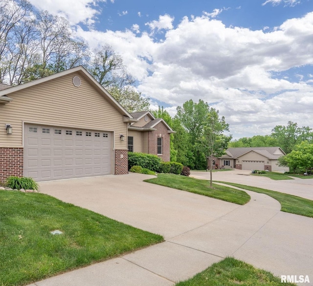 11 Musket Ct, Le Claire, IA 52753 - view of front of house with brick siding, driveway, a front lawn, and an attached garage