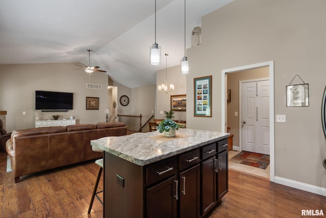 11 Musket Ct, Le Claire, IA 52753 - kitchen with a breakfast bar, a ceiling fan, light countertops, dark wood-style floors, and decorative light fixtures