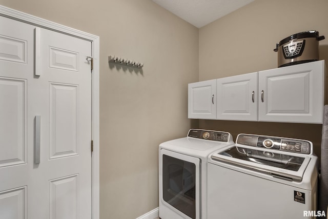 11 Musket Ct, Le Claire, IA 52753 - washroom with cabinet space, washer and clothes dryer, and baseboards