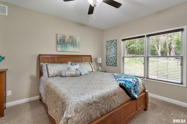 11 Musket Ct, Le Claire, IA 52753 - bedroom with light colored carpet, baseboards, and ceiling fan