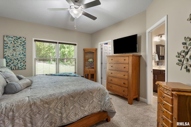 11 Musket Ct, Le Claire, IA 52753 - bedroom with light carpet, ceiling fan, and connected bathroom