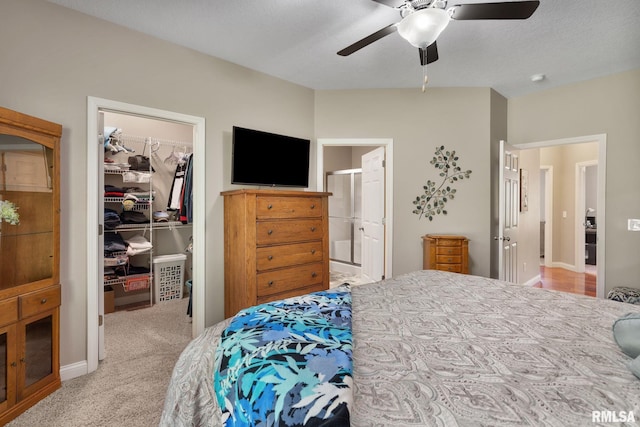 11 Musket Ct, Le Claire, IA 52753 - bedroom with a walk in closet, a closet, light carpet, ensuite bath, and a ceiling fan