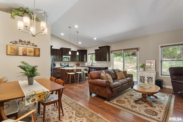 11 Musket Ct, Le Claire, IA 52753 - living room with light wood finished floors, a chandelier, recessed lighting, and high vaulted ceiling