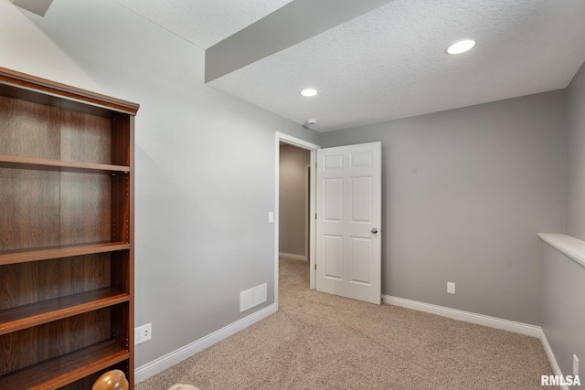 11 Musket Ct, Le Claire, IA 52753 - unfurnished bedroom with carpet flooring, a textured ceiling, baseboards, and recessed lighting