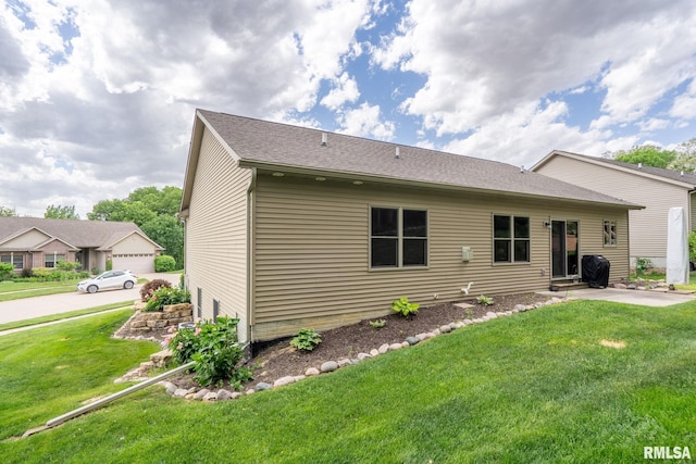 11 Musket Ct, Le Claire, IA 52753 - rear view of house with a yard and entry steps