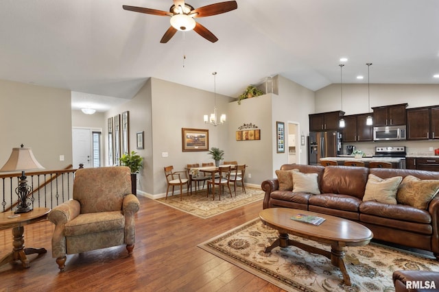 11 Musket Ct, Le Claire, IA 52753 - living room with ceiling fan, hardwood / wood-style floors, high vaulted ceiling, a chandelier, and baseboards
