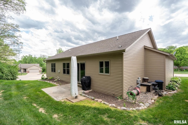 11 Musket Ct, Le Claire, IA 52753 - back of house featuring a lawn, a patio area, and a shingled roof