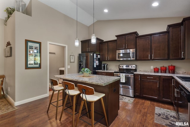 11 Musket Ct, Le Claire, IA 52753 - kitchen with stainless steel appliances, dark wood-style floors, dark brown cabinets, a kitchen island, and high vaulted ceiling
