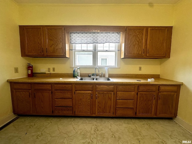 2213 Locust St, Eldorado, IL 62930 - kitchen with a sink, brown cabinets, light marble finish flooring, baseboards, and light countertops