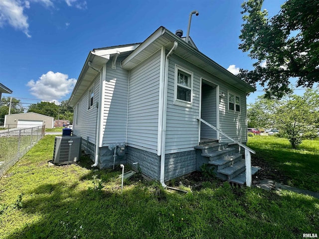 2213 Locust St, Eldorado, IL 62930 - view of property exterior featuring entry steps and central AC