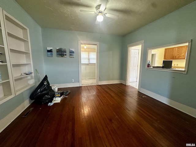 2213 Locust St, Eldorado, IL 62930 - unfurnished living room with ceiling fan, built in features, dark wood-style floors, and baseboards