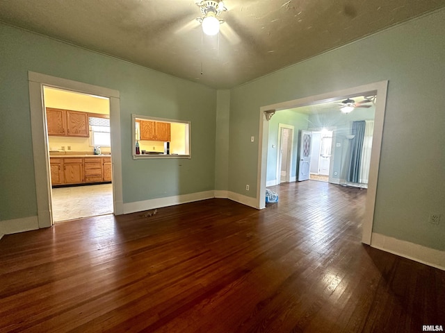 2213 Locust St, Eldorado, IL 62930 - empty room with ceiling fan, wood finished floors, and baseboards