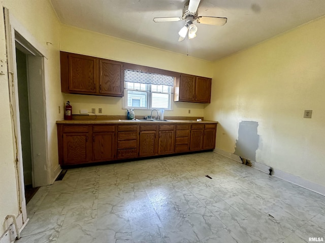 2213 Locust St, Eldorado, IL 62930 - kitchen with baseboards, a ceiling fan, brown cabinetry, light countertops, and a sink
