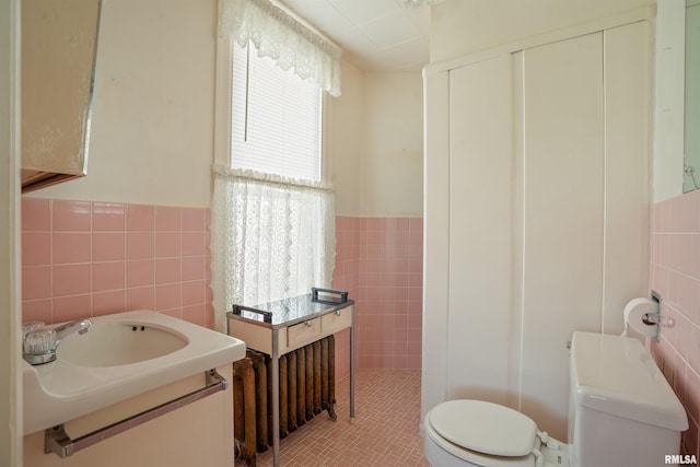 2006 Dixwell St, Davenport, IA 52802 - bathroom featuring tile walls, toilet, wainscoting, vanity, and tile patterned floors