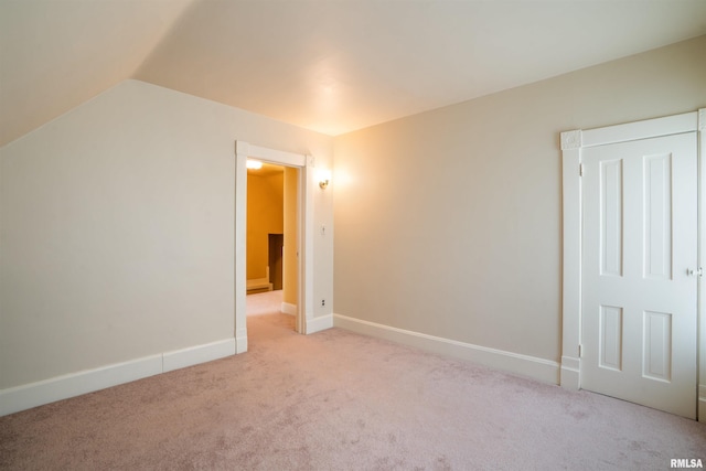 2006 Dixwell St, Davenport, IA 52802 - unfurnished bedroom with light carpet, vaulted ceiling, and baseboards