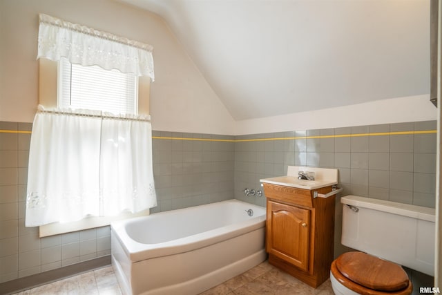 2006 Dixwell St, Davenport, IA 52802 - bathroom with tile walls, vaulted ceiling, a garden tub, and toilet