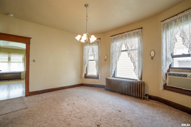 2006 Dixwell St, Davenport, IA 52802 - unfurnished dining area featuring radiator heating unit, carpet flooring, a chandelier, and healthy amount of natural light