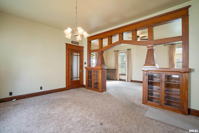 2006 Dixwell St, Davenport, IA 52802 - spare room featuring a chandelier, carpet, and baseboards