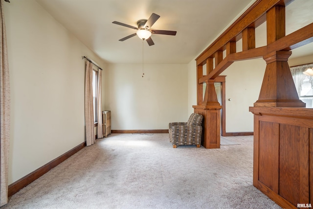 2006 Dixwell St, Davenport, IA 52802 - unfurnished living room featuring ceiling fan, carpet flooring, and baseboards