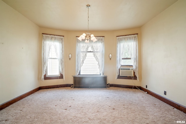 2006 Dixwell St, Davenport, IA 52802 - unfurnished dining area with radiator, a chandelier, carpet flooring, and baseboards